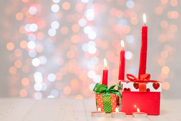 Gift boxes with candles on festive background. Empty space for your text. Valentine day concept