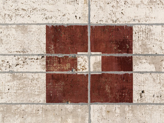 Wall of concrete slabs with a picture of rectangles. Rough surface with peeling paint brown and...