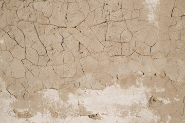 Concrete wall texture with cracked plaster. Weathered uneven rough surface. Perfect for background and grunge design.