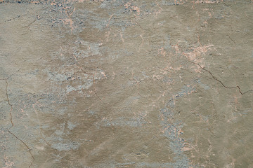Concrete wall texture with cracked plaster. Weathered uneven rough surface. Perfect for background and grunge design.