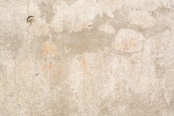 Concrete wall texture with cracked plaster. Weathered uneven rough surface. Perfect for background and grunge design.