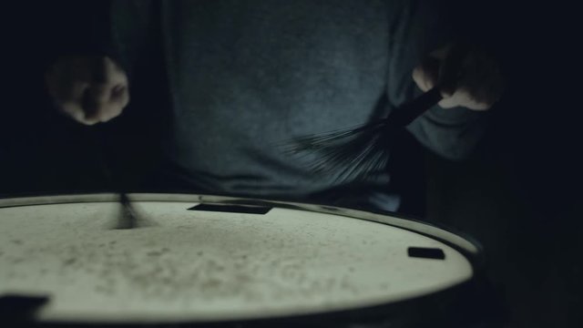 close-up - the drummer plays with brushes on a snare drum, home lesson training