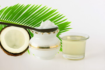 coconut oil in jar and spoon with coconut in white background