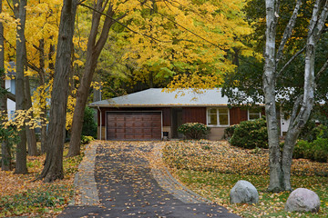 ranch bungalow surrounded by trees with fall colors
