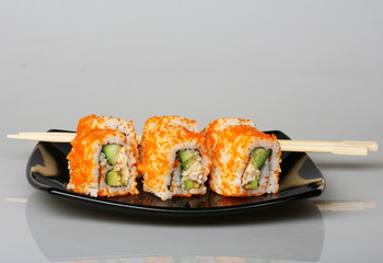 japanese  rolls on black plate.