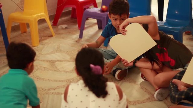 Kids playing with cardboard Ten Commandments tablets