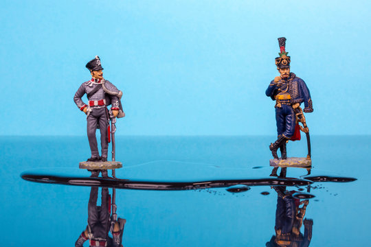 Two hussars from the Napoleonic Wars stand in front of a puddle of water