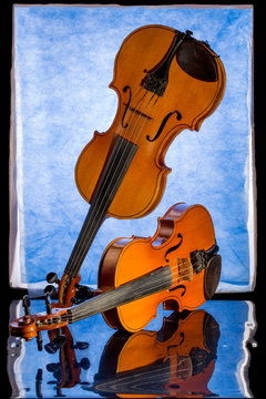 Still life with two violins and reflection