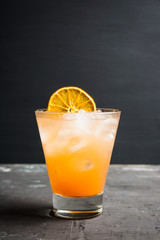 Fresh cocktail with grapefruits on the rustic background. Selective focus. Shallow depth of field.