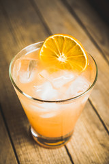 Fresh cocktail with grapefruits on the rustic background. Selective focus. Shallow depth of field.