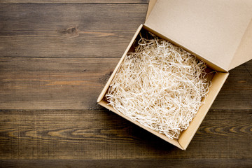 E-commerce. Delivery of goods that was purchased online. Empty cardboard box with cut paper on dark...