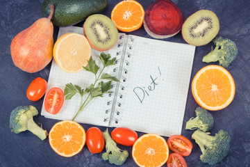 Natural fruits with vegetables as source vitamins and notepad with word diet, healthy nutrition concept