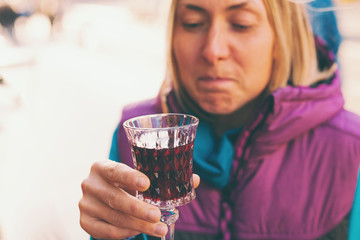 Woman holding a glass of red wine.