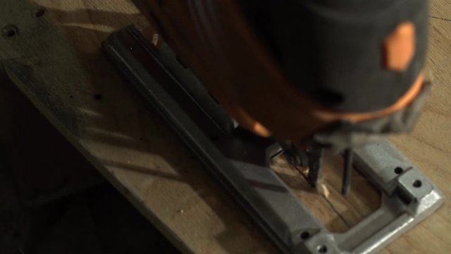 Male Carpenter Cuts A Piece Of Plywood