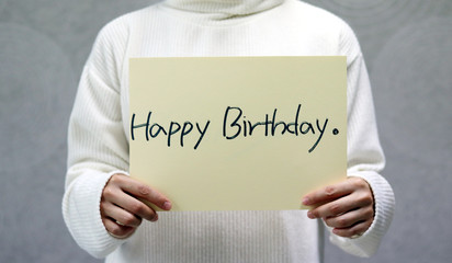 Woman wearing a white sweater and handwritten letter, Happy birthday
