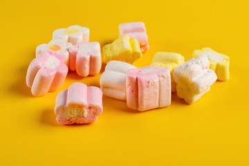 Fototapeta na wymiar colorful marshmallow on a yellow background