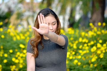 Young Filipina Woman Gesturing Stop