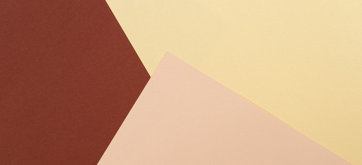Color papers geometry composition background with yellow beige and brown tones