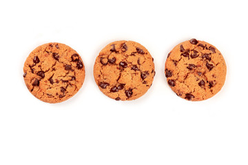 Three freshly baked chocolate chip cookies, shot from the top on a white background with a place for text