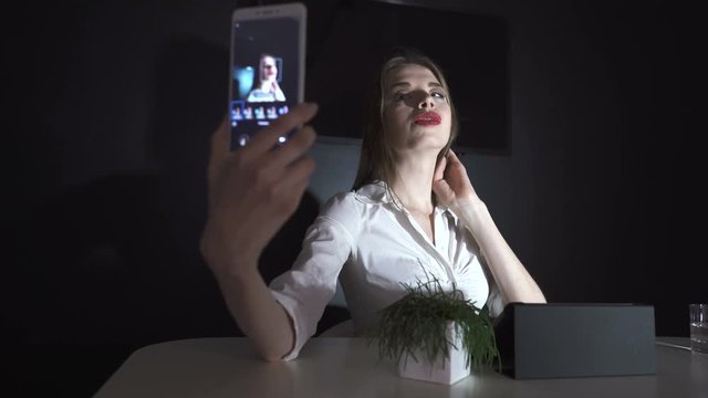 4К. Young pretty business woman  do selfie photo  by smartphone in office