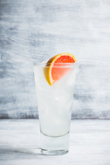 Fresh cocktail with grapefruits on the rustic background. Selective focus. Shallow depth of field..