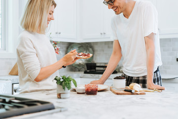 Woman spreading vegan cream cheese on a toast