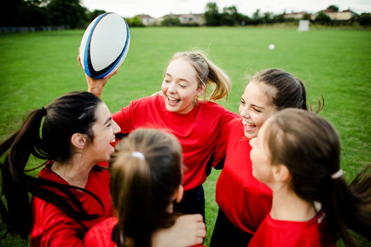 Cheerful young rugby players on the field