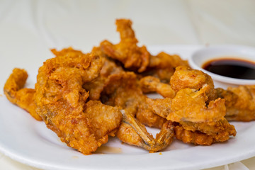 Close up shot of deep fried frog leg
