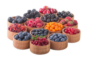 berries in wooden cups isolated on white background
