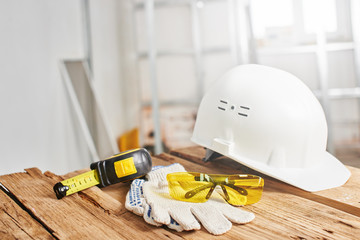 Home repairs. Construction tools, bricks and helmet on the wooden table