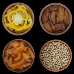 set of peppercorns in wooden cups isolated on black background