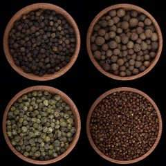 set of peppercorns in wooden cups isolated on black background