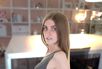 fashion young woman standing in loft apartment looking at camera