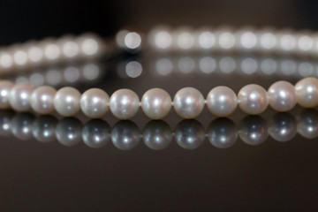 Pearl necklace on black background
