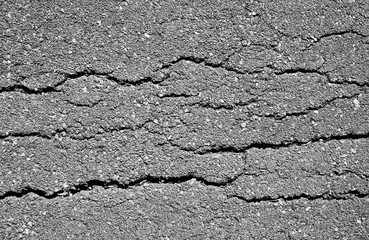 crack and texture of asphalt road - top view background.