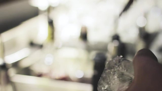 Bartender breaking ice with pick