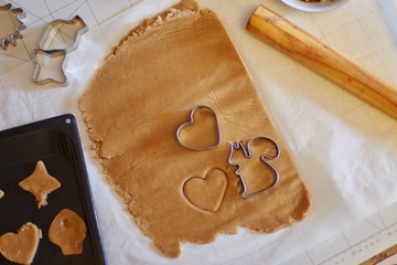 Cookies cutter shapes on raw dough, heart shape,  squirrel. Different cutter shapes as a...