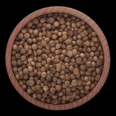 coriander seeds  in wooden cup isolated on black background. top view