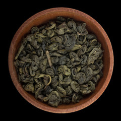 green tea  in wooden cup isolated on black background. top view