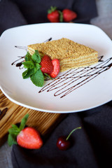 Close-up dessert is a piece of cake or puff cake with cream.