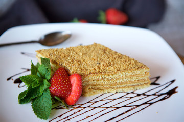 Close-up dessert is a piece of cake or puff cake with cream.