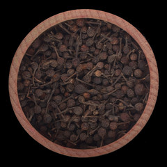 Piper borbonense in wooden cup isolated on black background. top view