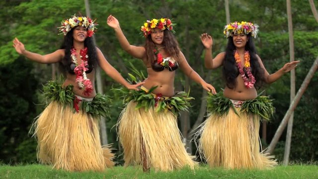 Young female group of Tahitian hula dancers performing outdoor barefoot in traditional costume Tahiti French Polynesia South Pacific
