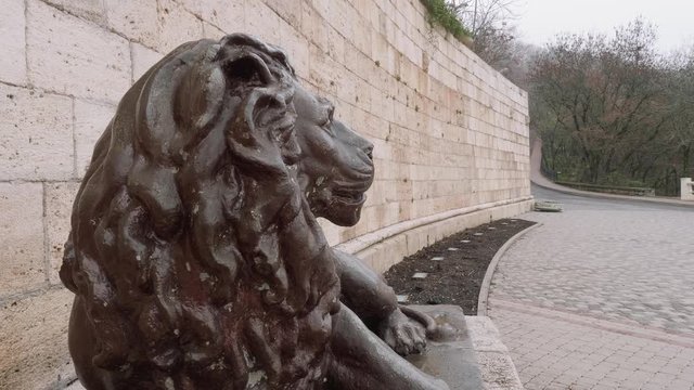 Bronze satue of lion at entrance into cave and Proval lake.