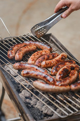 Grilling sausages on barbecue grill outdoor