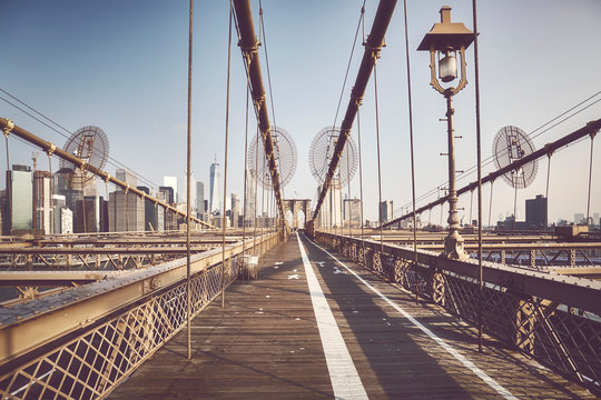 Wide angle view of the Brooklyn Bridge at sunrise, color toned picture, NYC.