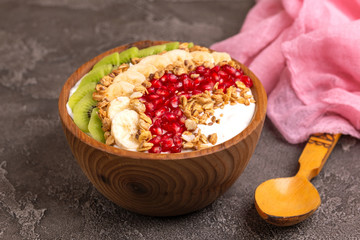 Vanilla acai bowl with kiwi, banana, pomegranate and granola