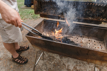 Man's hand preparing preparing for grilling