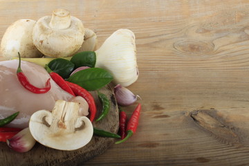 champignons with spices on wooden background