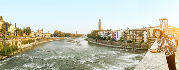 Panoramic cityscape view of Verona old town and bridge over Adige river. Travel destination in...